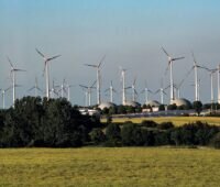 Im Vordergrund Felder, im Hintergrund Windkraft- und Biogasanlagen