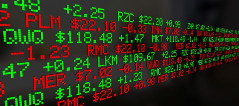 Grafik mit Börsentickersymbolen und Daten in rot und grün.