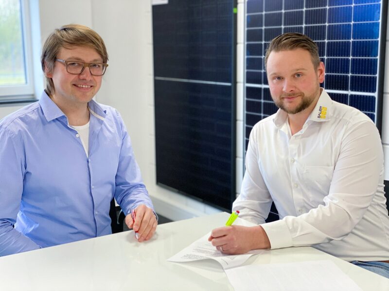 Zu sehen die die Geschäftsführer Hermann Schmees von Redpoint New Energy und Andreas Bauer von Bauer Solartechnik bei der Vertragsunterzeichnung