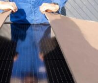 Ein Mensch öffnet einen Karton mit PV-Modulen, der Photovoltaik-Zubau in Niedersachsen im Jahr 2024 belief sich auf rund 1,6 GW.