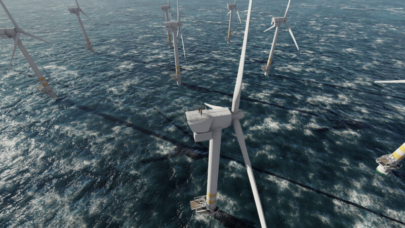 Zwei Arbeiter auf der Spitze einer Windenergieanlage in einem Offshore-Windpark
